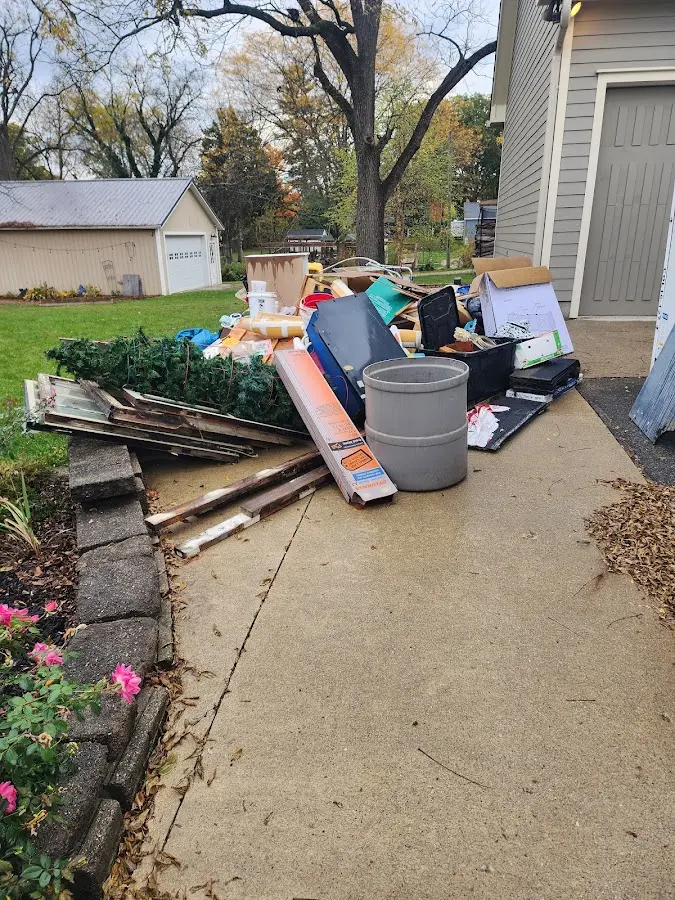 Dumpster being loaded with debris for 12 Yard Dumpster Rental in Chesterton